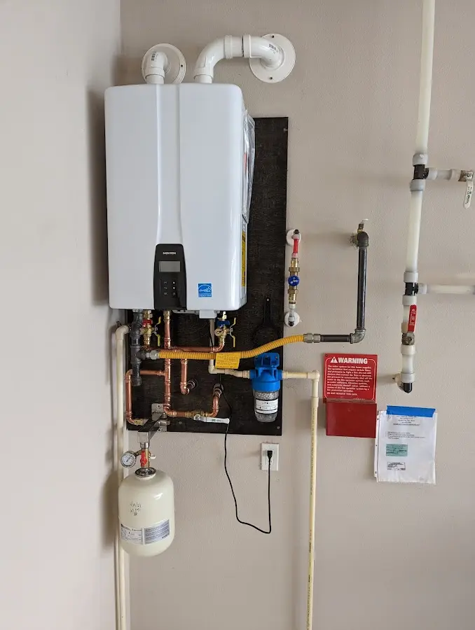 Professional plumber installing copper piping in a Concord home